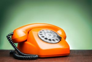 Vintage phone on table not being answered by failing lawn care company