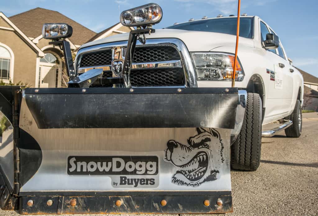 Snow plow hooked up to a pickup truck
