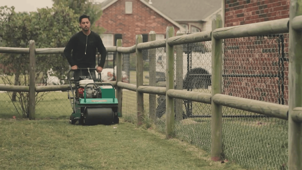 landscaping-employee-using-fertilizer-on-lawn