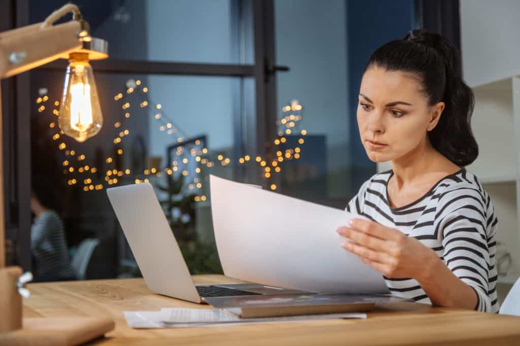 Smart professional businesswoman studying the pricing document