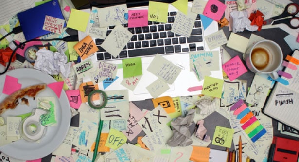 desk full of sticky note tasks