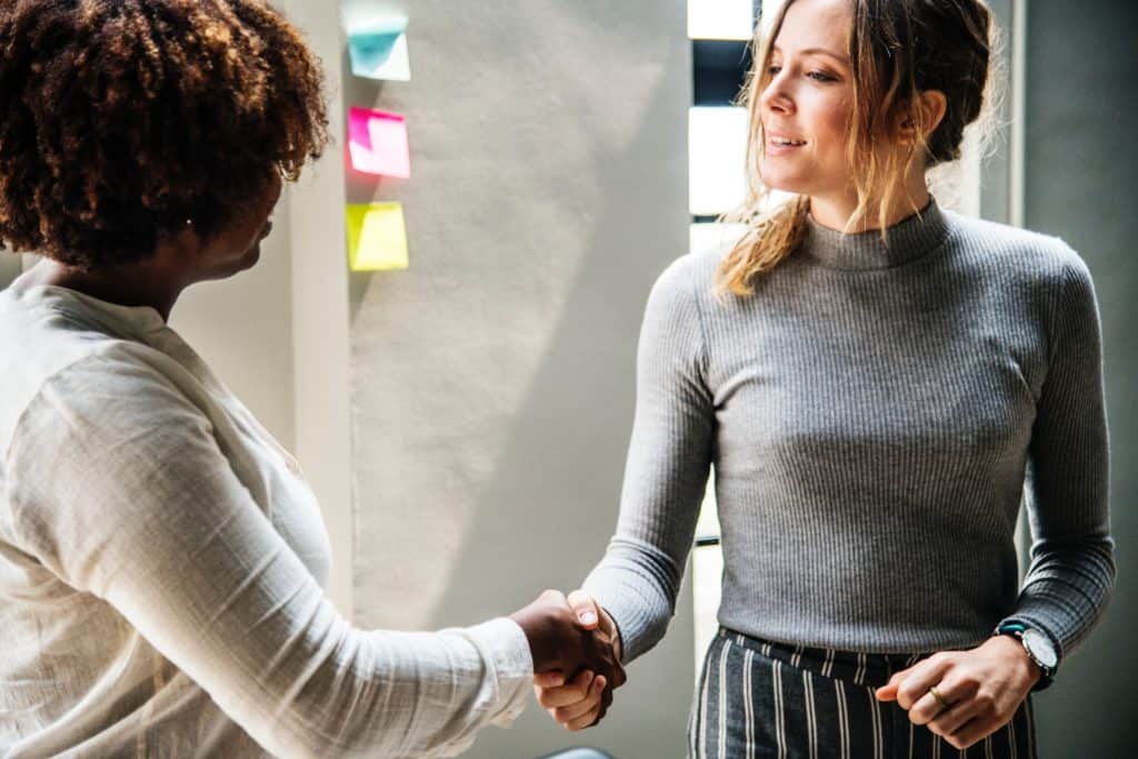 two-women-shaking-hands